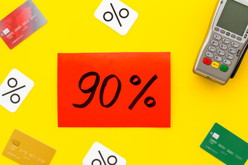 Sales with discount percentage sing concept. Online shopping. Top view of a POS payment terminal and credit cards