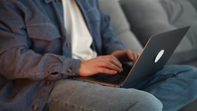 A student with a laptop does homework while sitting on the sofa.
A man studies online.
Online training in college.
Distance learning during a pandemic