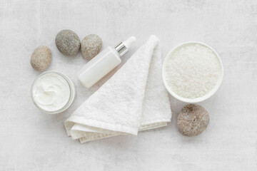 Spa set with cosmetic products with white flowers, top view