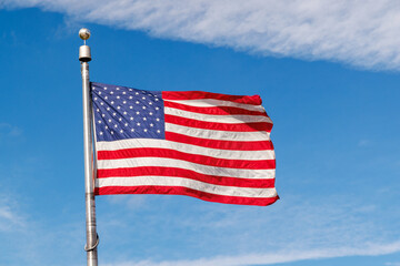 American flag waving against a blue sky
