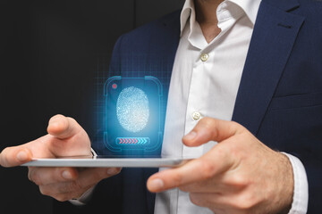 Businessman holding tablet with fingerprint scan. Fingerprint security concept.