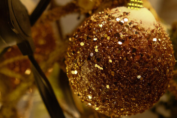 New Year's toy. Decorated Christmas tree on a blurry, sparkling and fabulous background. Garland and bokeh. Bright Lights.
