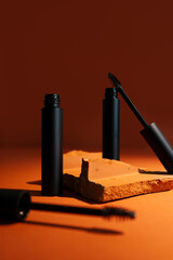 Close-up mockup of empty smooth mascara with delicate brush on soft, blurry, expensive background. Elegant brick effect adds a touch of luxury, perfect for beauty and makeup themes.