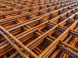 Pile of Rusty Quadratic Steel Reinforcement Mesh Rebar Grid at Construction Site: A Minimalist Perspective on Construction Materials and Industrial Aesthetics