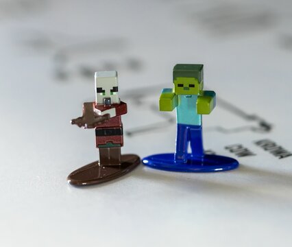 Close-up of Jada brand Minecraft figurines including Villager and Zombie on a white table