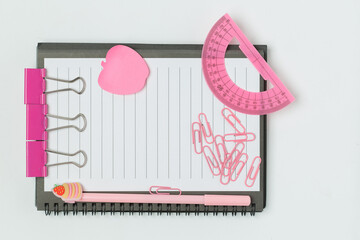 A vibrant collection of office and school supplies, including scissors, pens, sticky notes, paper...