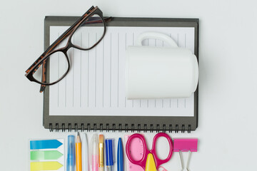 A vibrant collection of office and school supplies, including scissors, pens, sticky notes, paper...