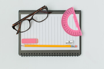 A vibrant collection of office and school supplies, including scissors, pens, sticky notes, paper...