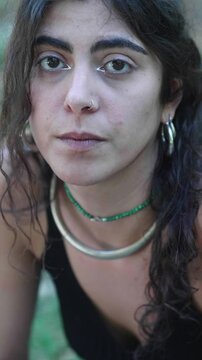 Unhappy Young Woman Looks at Camera Dejectedly