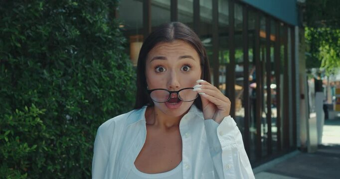 Reality hits woman pulls off her glasses face clearly showing signs of shock frustration and disbelief. Young adult female emotional reaction intensifies she removes glasses face full of disbelief.