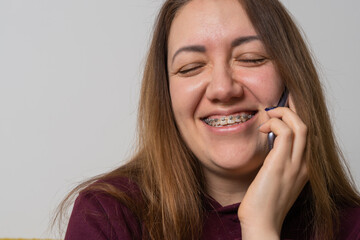 Woman wear braces using smartphone at home