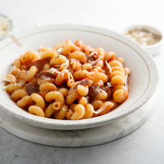 Pasta with tomato sauce and smoked ham