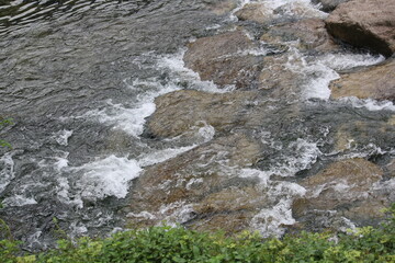Beautiful image of flowing waves of clear water of Daecheongcheon Stream