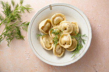 Homemade dumplings with butter and dill