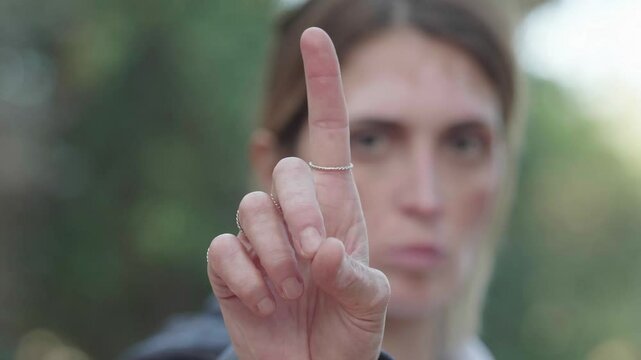Close-up of woman with vitiligo saying no with her finger