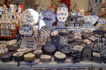 Display of various ceramic dishes with fish patterns on a table market