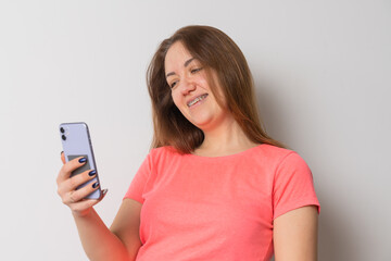 Woman wear braces using smartphone at home