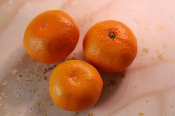 A group of mandarins. The texture of the peel. Abstract background. New Year's mood.