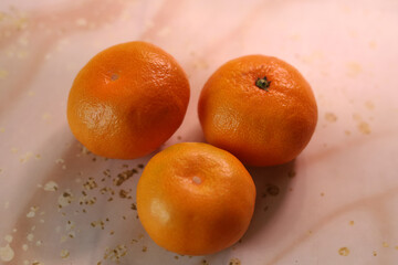 A group of mandarins. The texture of the peel. Abstract background. New Year's mood.
