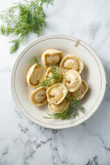 Homemade dumplings with butter and dill