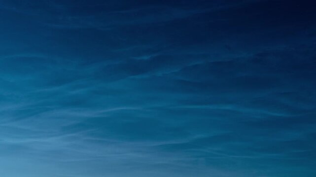 Close-up timelapse of slowly moving noctilucent clouds. Ethereal feeling.