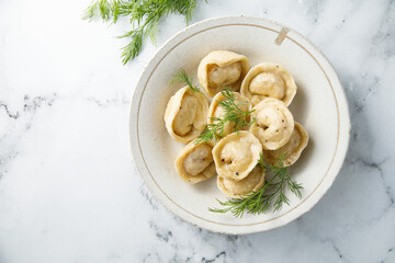 Homemade dumplings with butter and dill