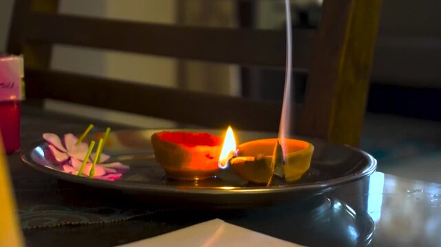 Traditional Indian Pooja Plate with Burning Dhoop and Clay Diya in Uttarakhand, India