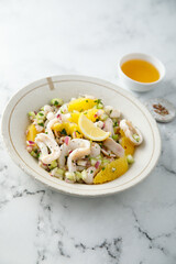 Squid salad with orange and red nion