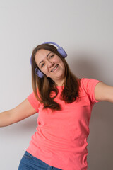 Modern woman smiling with braces on her teeth and listening to music