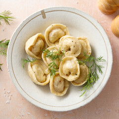 Homemade dumplings with butter and dill