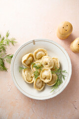 Homemade dumplings with butter and dill