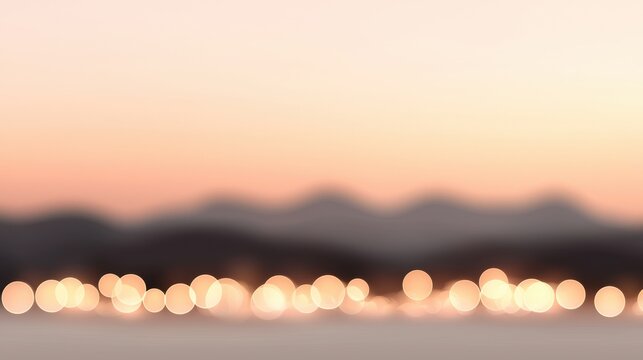 A blurry image of mountains with a pink sky in the background
