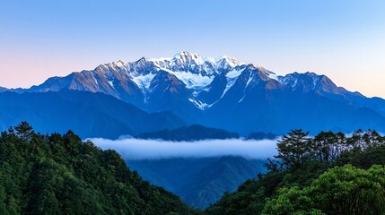 Fototapeta premium Majestic Snow-Capped Mountain Range Shrouded in Misty Dawn Light,Tranquil Wilderness Landscape
