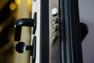 Door lock bolts on an open armored entrance door. Locking mechanism on a door lock. Rubber tubular...