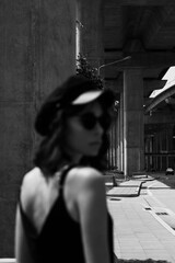 Black and white photo of a girl in classic clothes posing on the streets of Bangkok.
