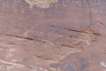 Detail of indigenous culture Petroglyphs etch in the walls along Potash Road in Moab Utah