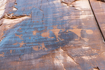 Detail of indigenous culture Petroglyphs etch in the walls along Potash Road in Moab Utah