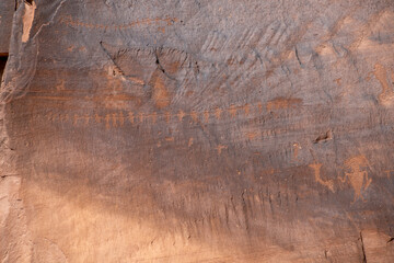 Detail of indigenous culture Petroglyphs etch in the walls along Potash Road in Moab Utah