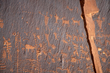 Detail of indigenous culture Petroglyphs etch in the walls along Potash Road in Moab Utah