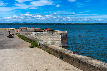 Benches on a damaged concrete pier on the Sainte Lawrence river