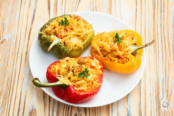 Baked stuffed pepper ( paprika ) with rice , carrot and meat . Top view on rustic background