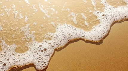 Gentle waves lapping against a sandy beach at sunset.