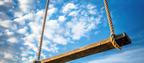 Obraz premium Swing Set With Rope Against Sky And Cloud Backdrop