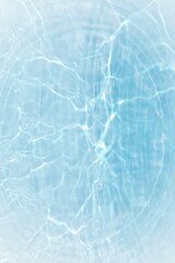 Blue water with ripples on the surface. Defocus blurred transparent blue colored clear calm water surface texture with splashes and bubbles. Water waves with shining pattern texture background.
