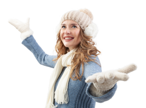 A cheerful and joyful woman, dressed in warm winter clothes, hat, scarf, sweater and gloves stands with open arms. Her face shines with happiness and excitement as dreams of a white Christmas holiday