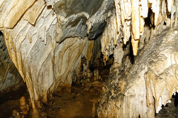 Stalactites and stalagmites in a cave, formed over thousands of years by dripping limestone water.