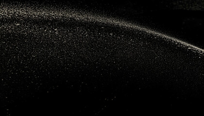 Obraz premium Abstract background image featuring a scattering of light particles on a dark surface, resembling stars or glitter. Ideal for design projects needing a cosmic or magical aesthetic.