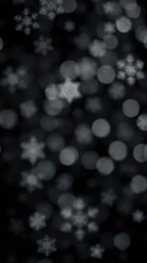 Naklejka premium Abstract bokeh of white snowflakes on black background, seasonal