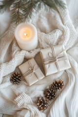 Flat lay of eco-friendly holiday decor with simple wrapped gifts, candles, pinecones, and organic textures on a light linen cloth in earthy tones
