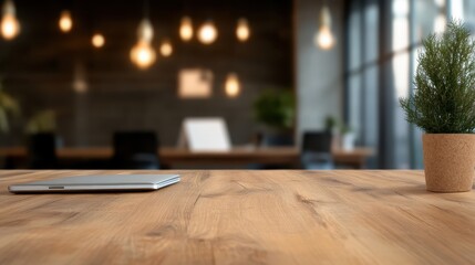 An organized office setup featuring a wooden table with a tablet placed horizontally and a potted plant, surrounded by blurred background elements, under soft lighting.